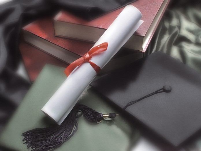 Photo, diploma, mortarboard and booksColorHigh res